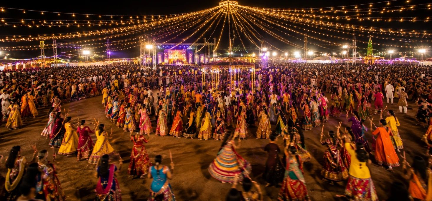 Large Navratri garba dandiya night celebration in Ahmedabad with colorful lighting
